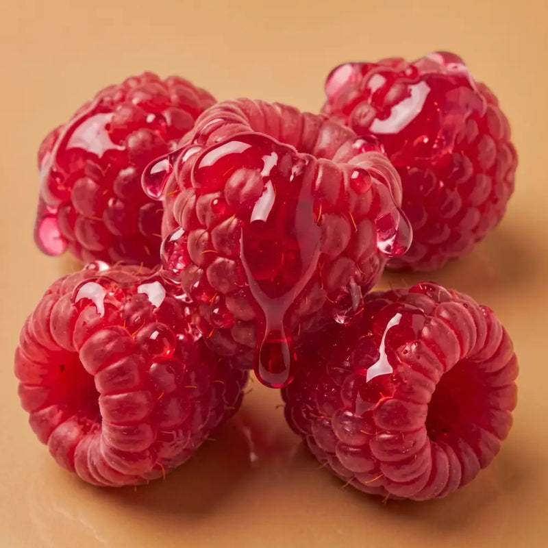 Fresh red raspberries covered with glossy, raspberry-colored glycerin fragrance note perfumes